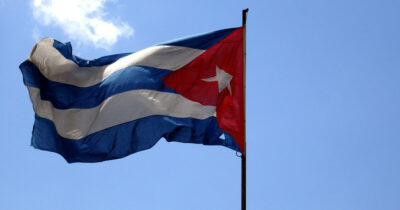 The flag of Cuba in front of a blue sky