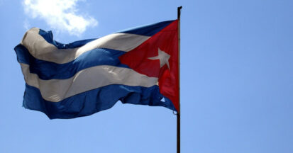 The flag of Cuba in front of a blue sky