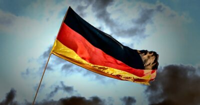 The flag of Germany in front of a cloudy sky