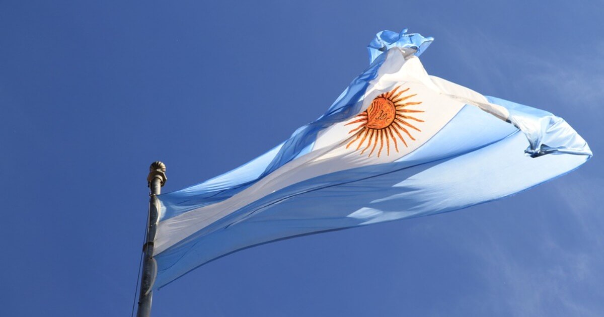 The flag of Argentina in the wind against a blue sky