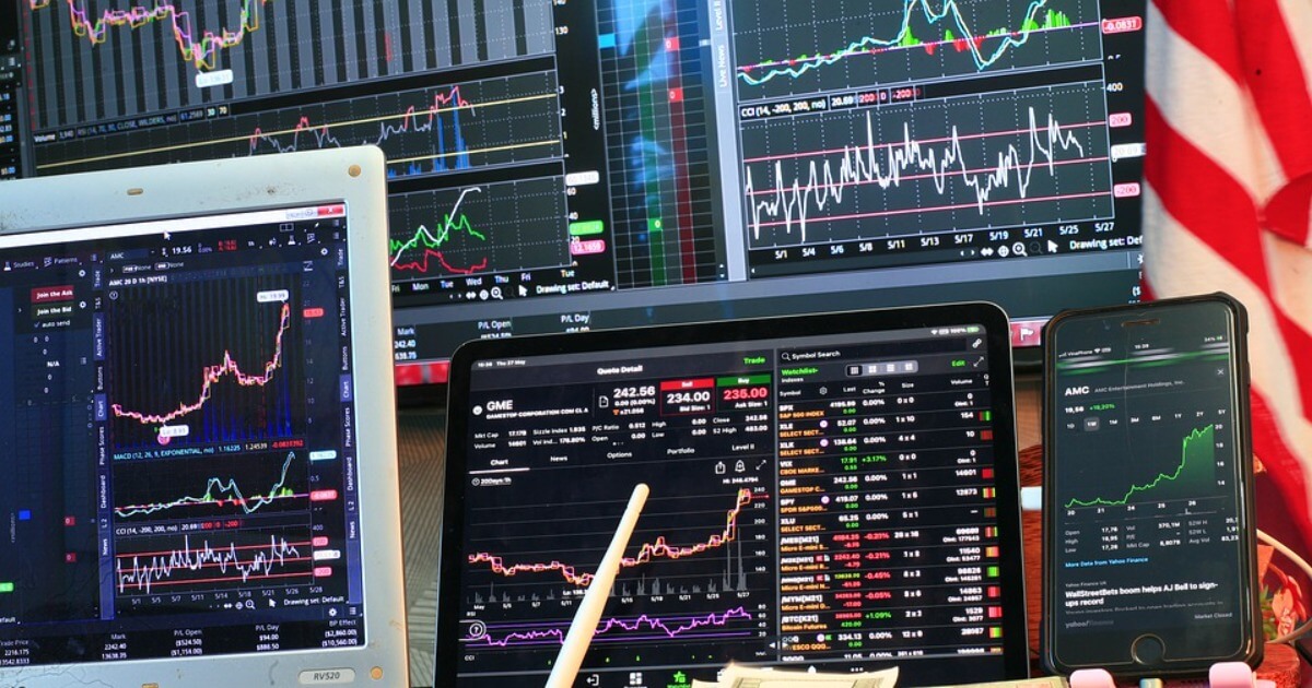 Computer screens displaying stock market