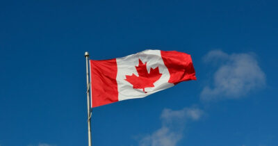 The flag of Canada against a blue sky