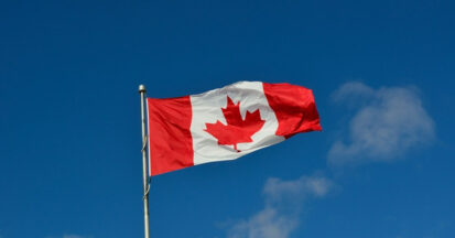 The flag of Canada against a blue sky