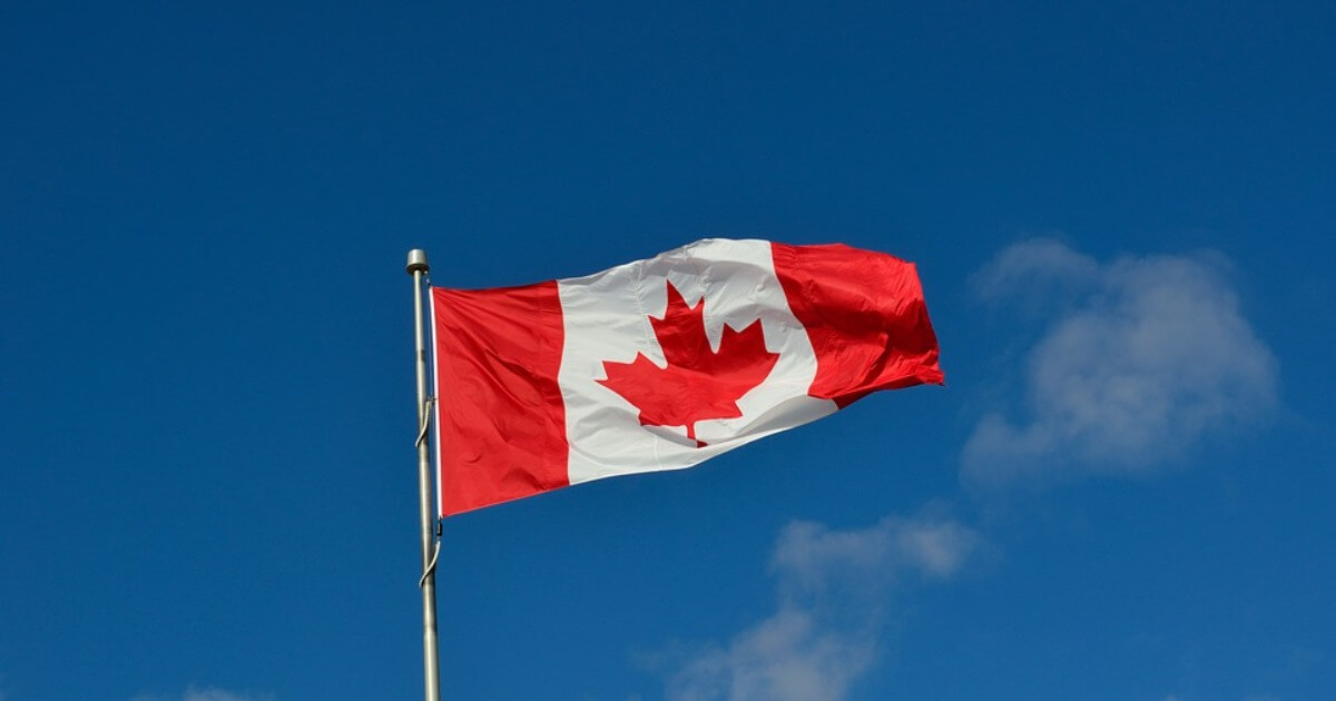 The flag of Canada against a blue sky