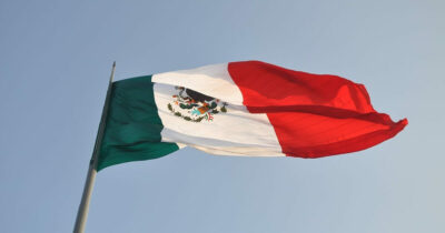 The flag of Mexico against a blue sky