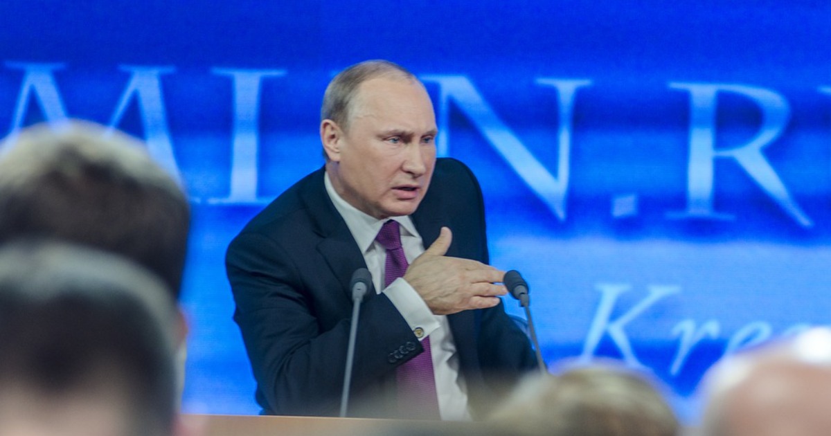 Vladimir Putin talking into a microphone